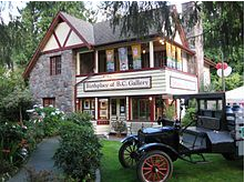BC Gallery, a photo of an older victorian style home with an old milk truck parked out front.