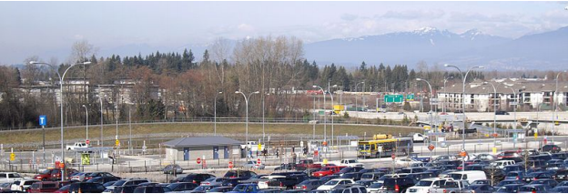 photo of Langley Bus Depo parking lot. Rows upon rows of parked vehicles.